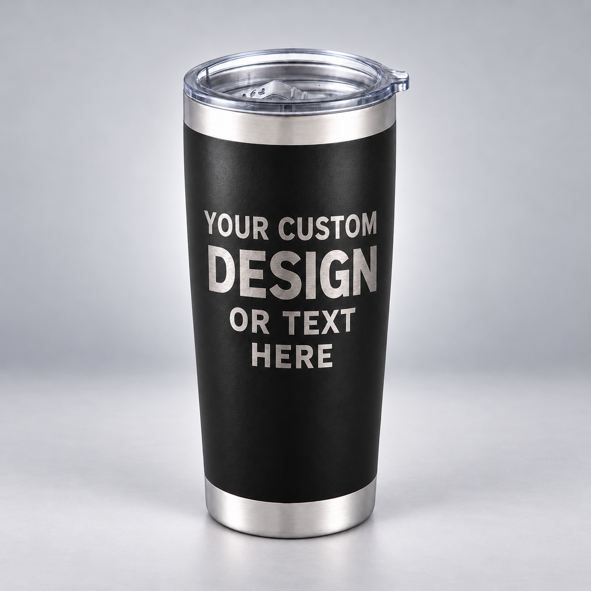 Black 20 oz tumbler with silver engraving preview reading YOUR CUSTOM DESIGN OR TEXT HERE