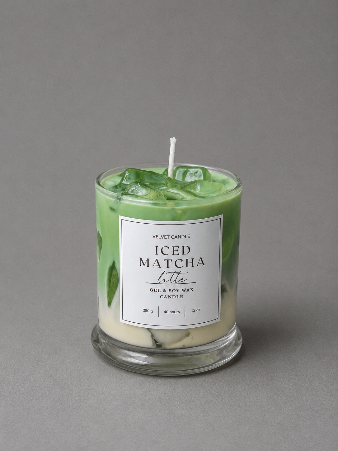 Green Iced Matcha Latte candle with translucent wax ice in a labeled clear glass
