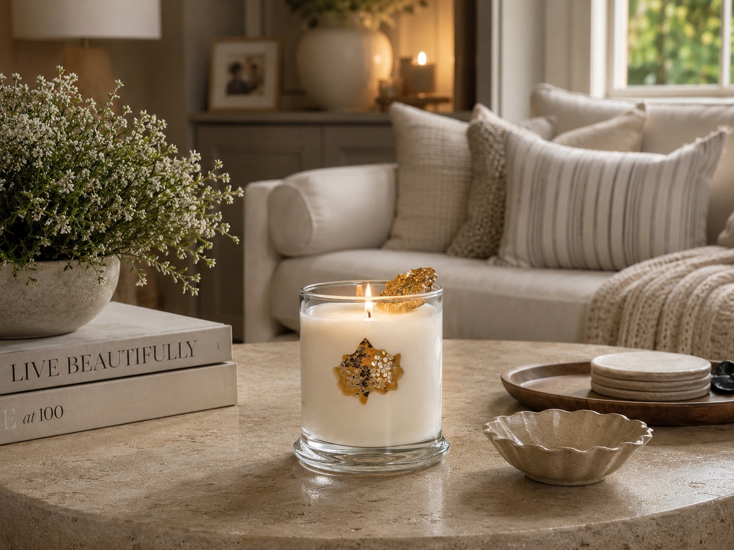 Lit Golden Autumn Maple Leaf candle in a cozy neutral living room