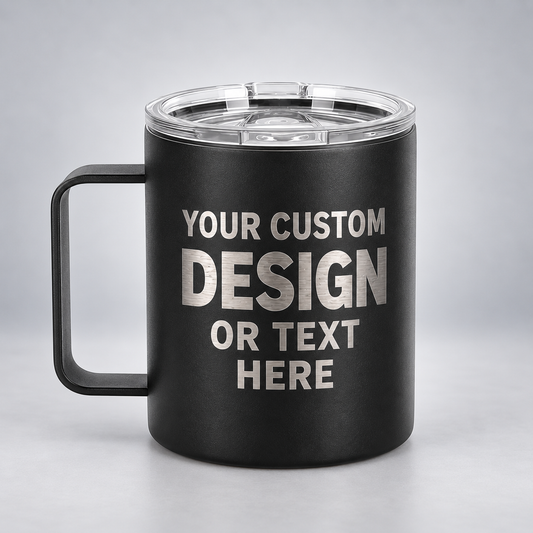 Illustrative black 12 oz handled coffee mug with silver YOUR CUSTOM DESIGN OR TEXT HERE engraving on a gray studio background