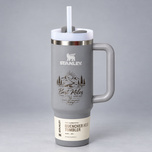 Custom laser-engraved gray Stanley tumbler on a neutral gray studio background