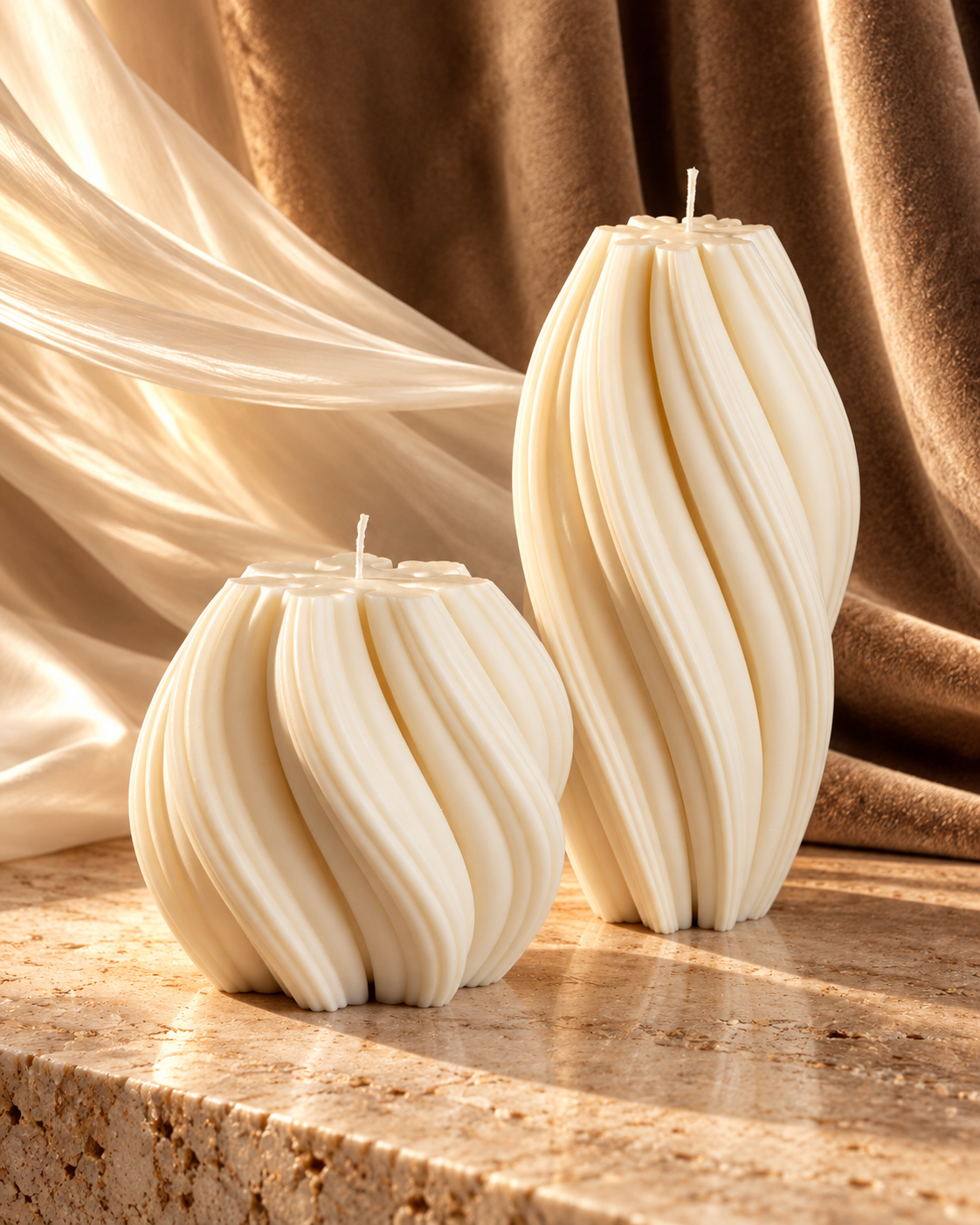 Medium rounded and tall elongated ivory wave candles displayed as a coordinated pair