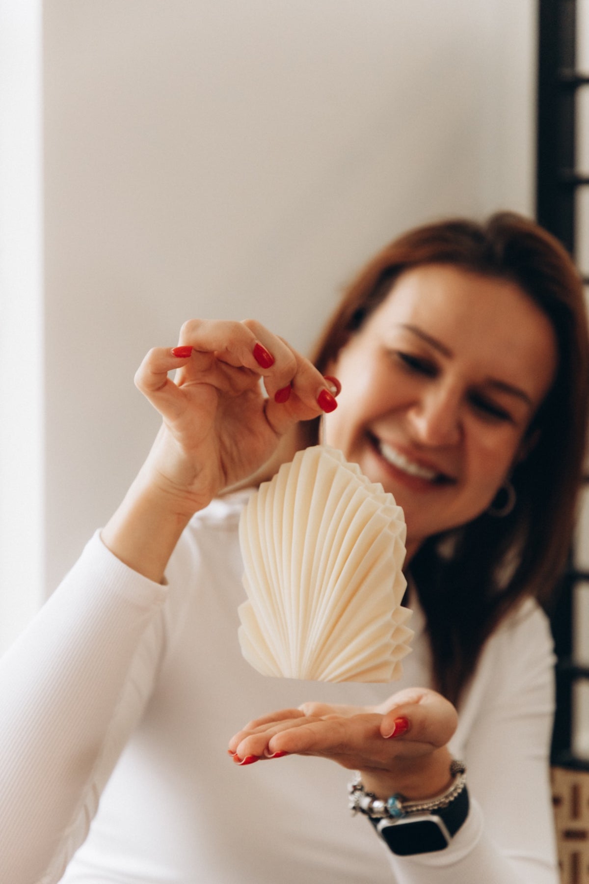 Marina, founder of Velvet Candle Company, holding a sculptural candle