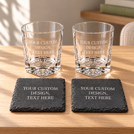 Personalized Whiskey Glass & Slate Coaster Set — 2 Glasses + 2 Coasters on a straight pale oak table in natural daylight