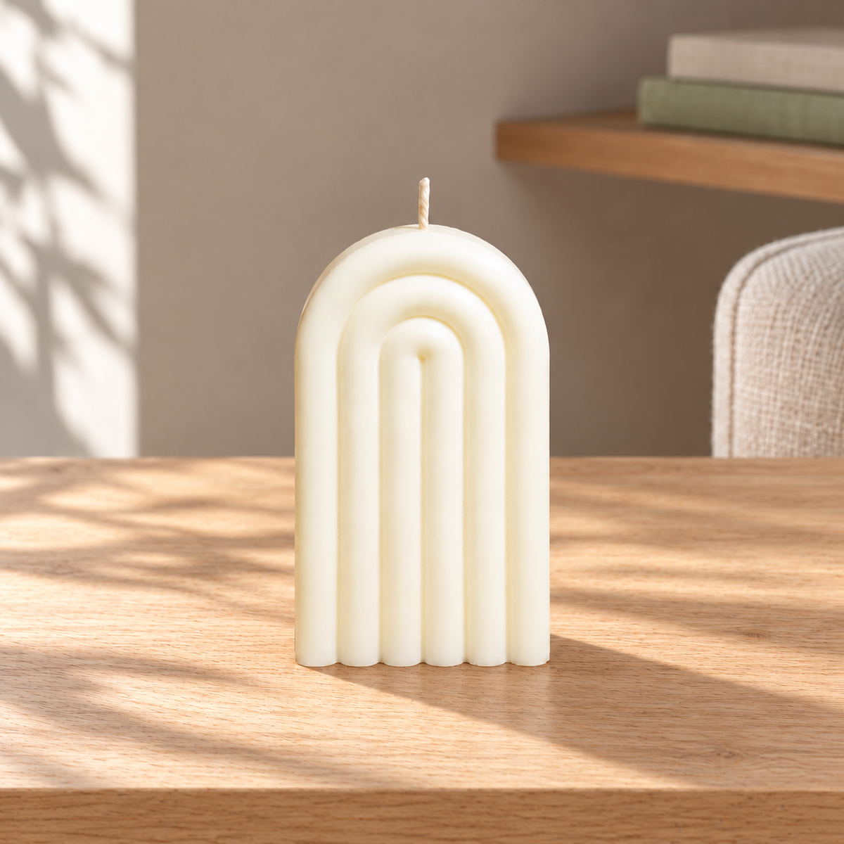 Arch Candle on a straight pale oak table in natural daylight