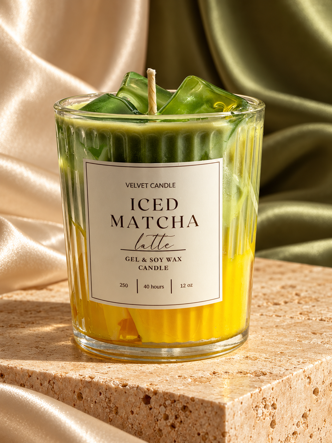 Yellow and green iced matcha latte candle in ribbed glass with satin and stone styling